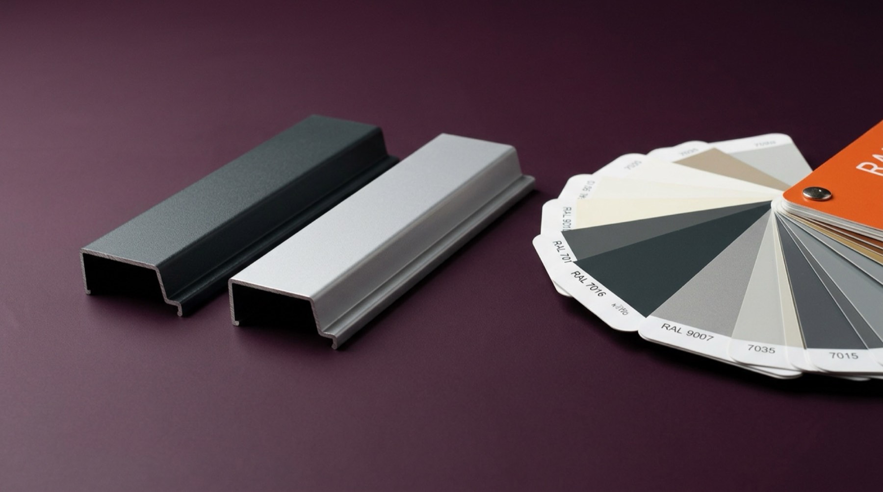 Two sill flashing profiles in different colours next to a RAL colour fan